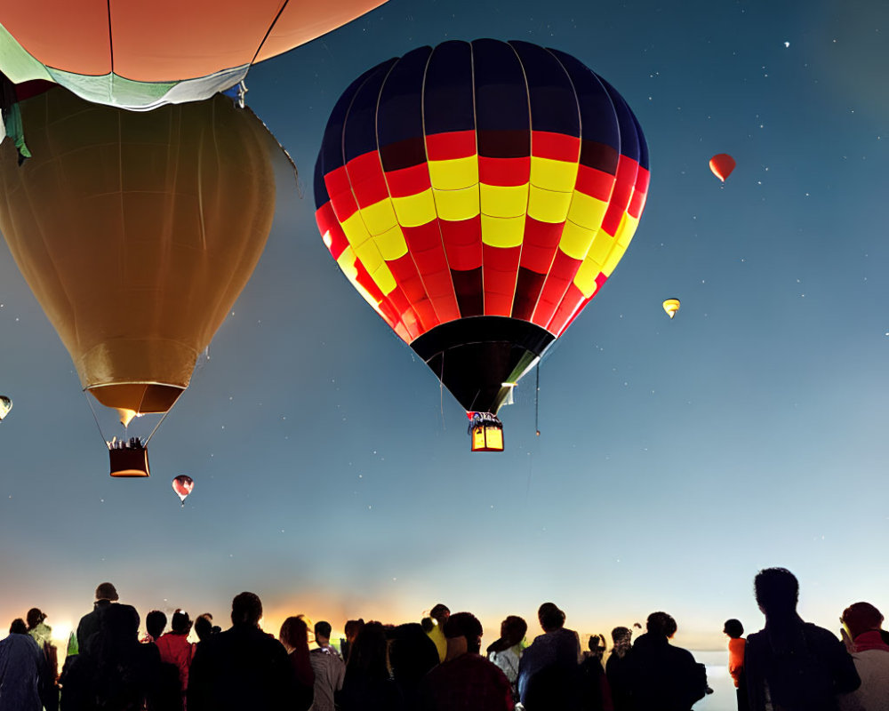 Dusk hot air balloons flight with silhouetted spectators.