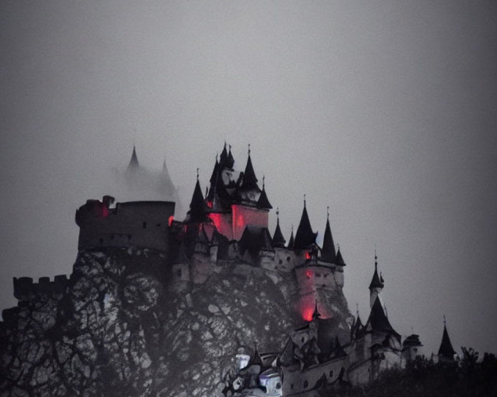 Misty castle on craggy hill under dusky sky