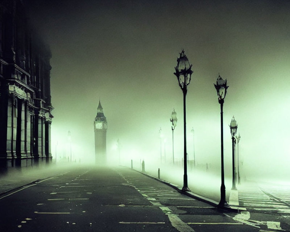 Misty street lamps on deserted road to fog-covered clock tower