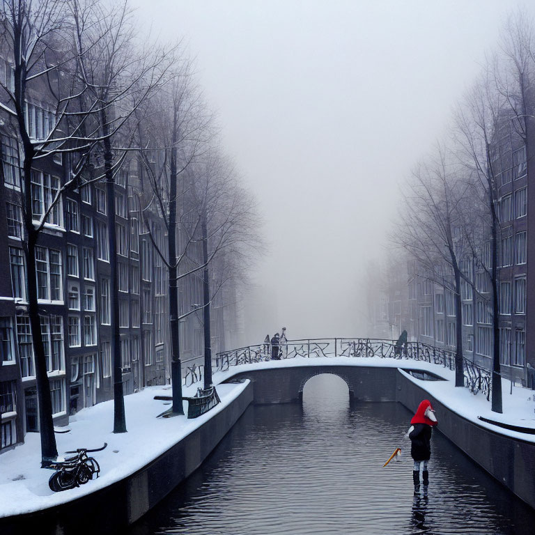 Snowy city canal scene with person shoveling snow, bike on bridge, and figures in fog