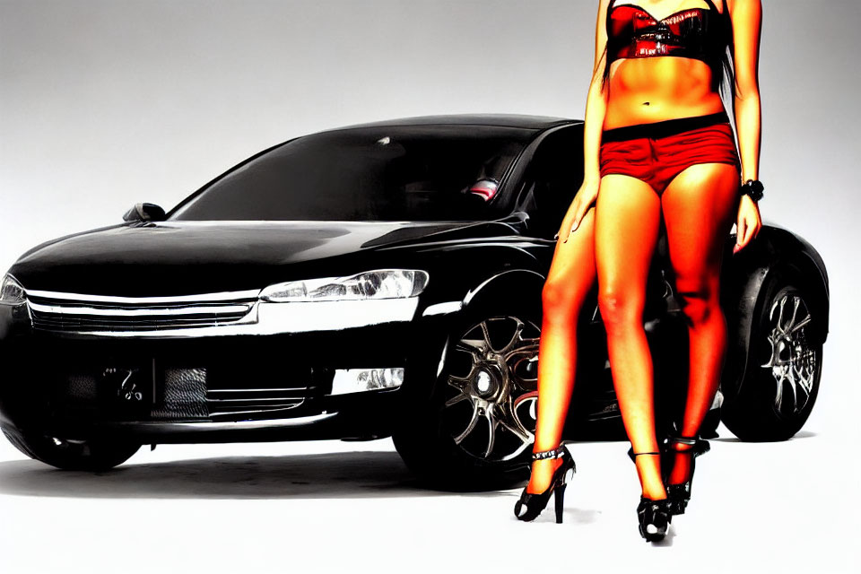 Stylish black car with person in red shorts and high heels
