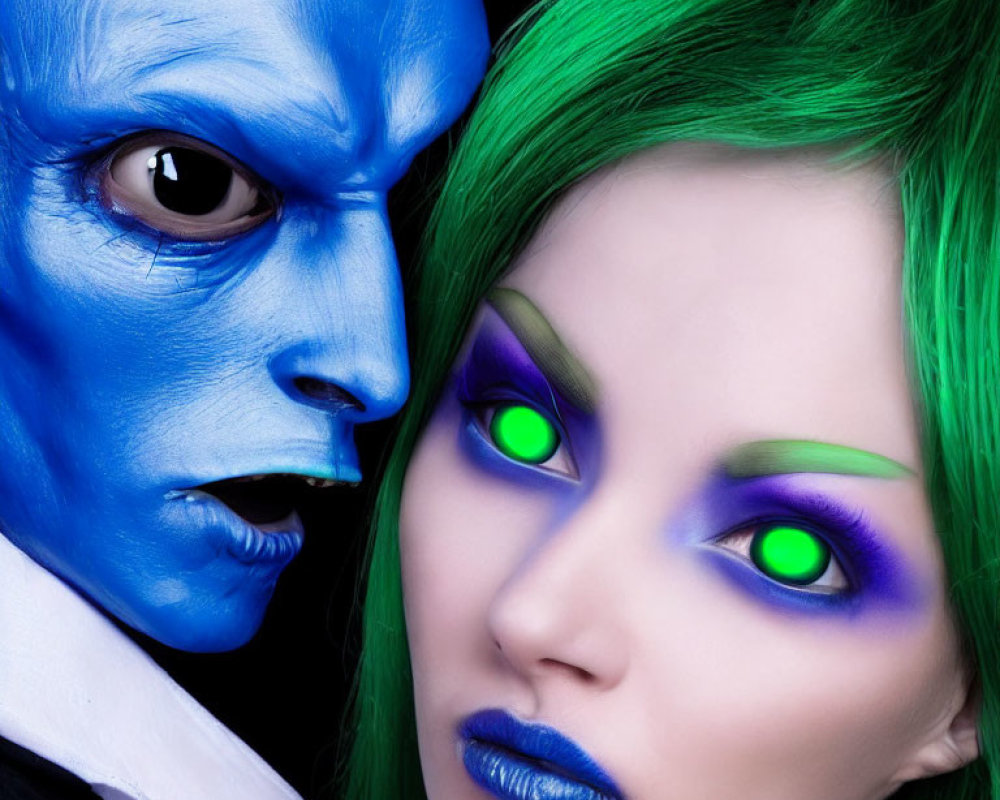 Two individuals with blue and green fantasy makeup and intense stares.
