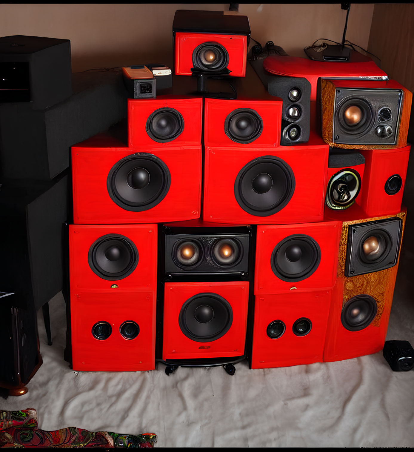 Assorted red and wood-finish speakers in home setting