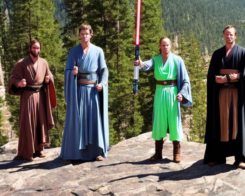 Four people in Star Wars Jedi costumes with lightsabers on rocky landscape with pine trees and clear sky