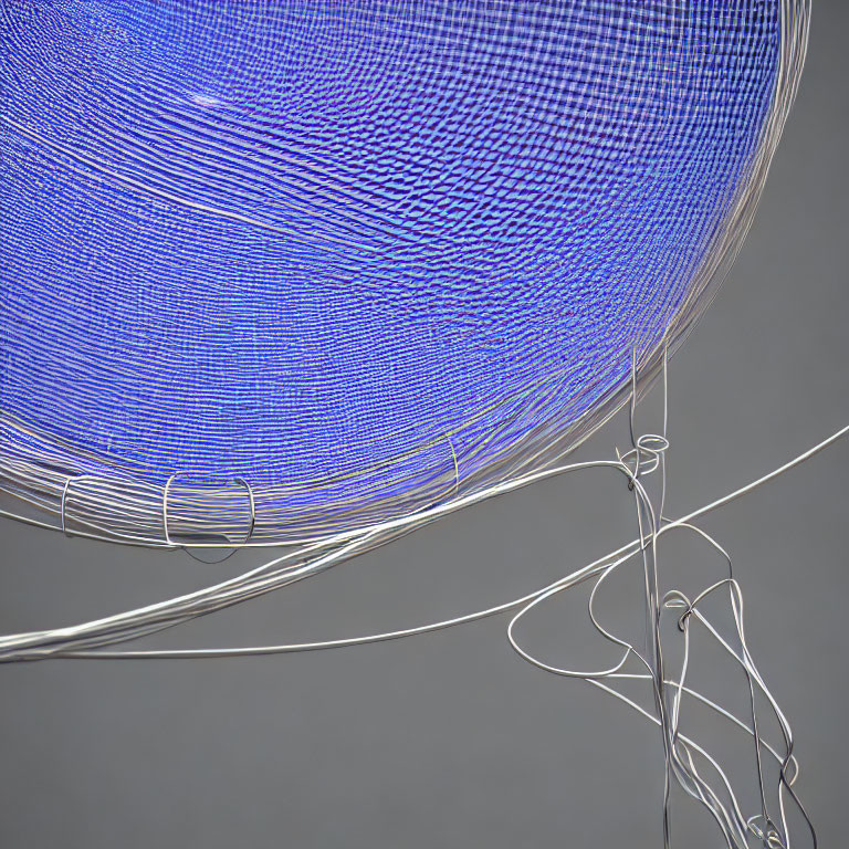 Abstract blue lines swirling to form sphere with white wires in foreground