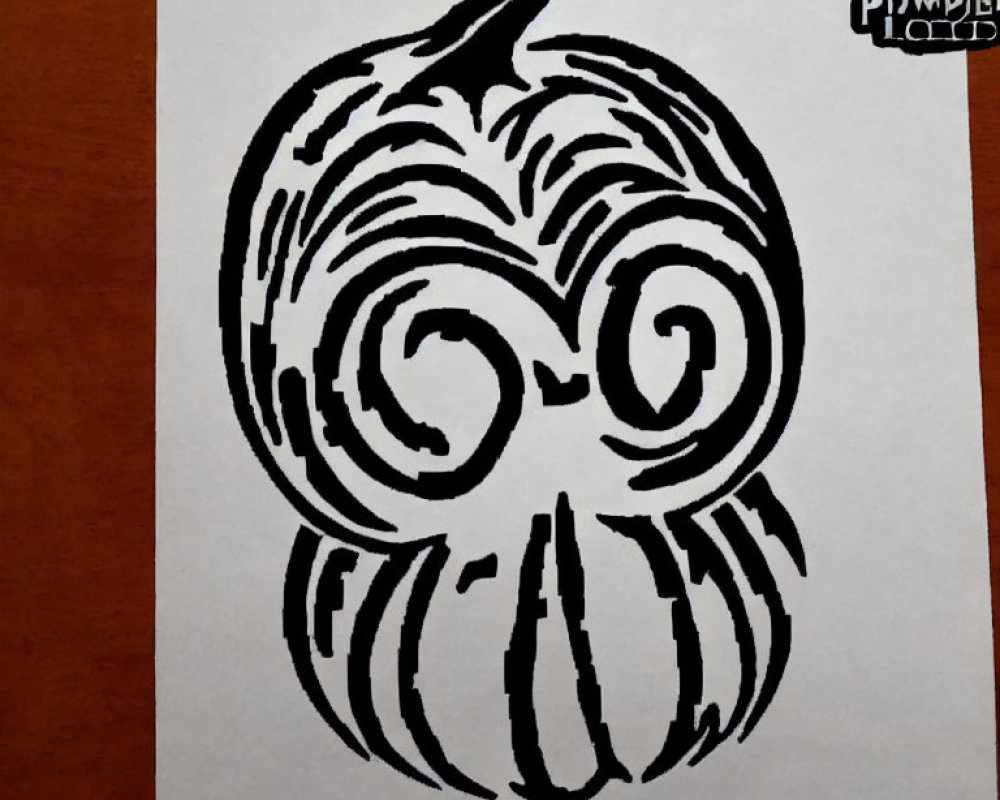 Monochrome pumpkin drawing with swirl eyes on paper