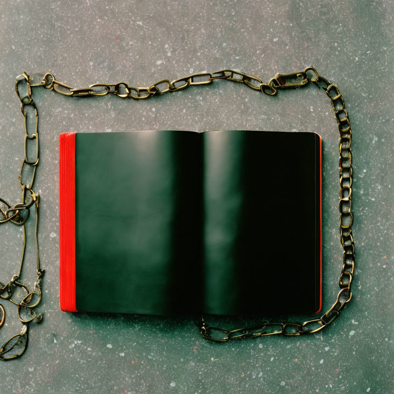 Blank Pages Black Book with Rusty Chain on Grey Surface