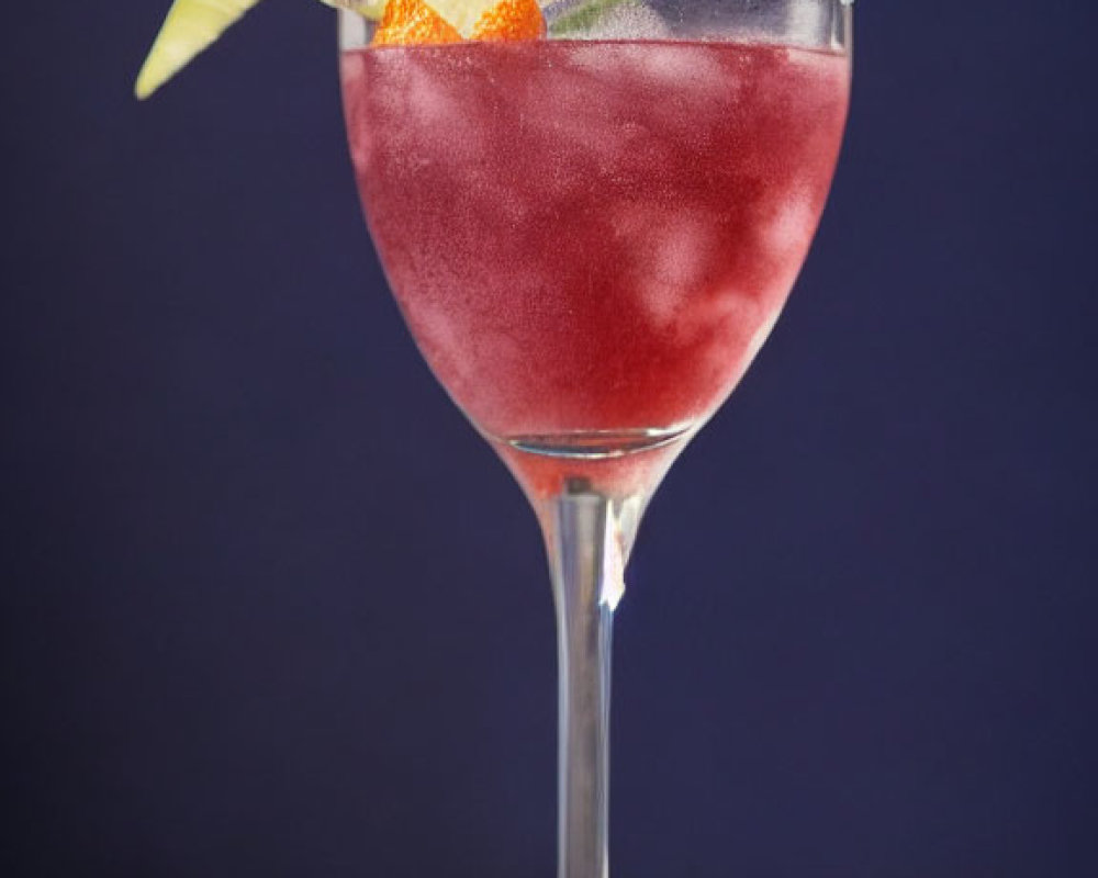 Red Cocktail with Sugar Rim, Lime Wedge, and Orange Peel on Blue Background