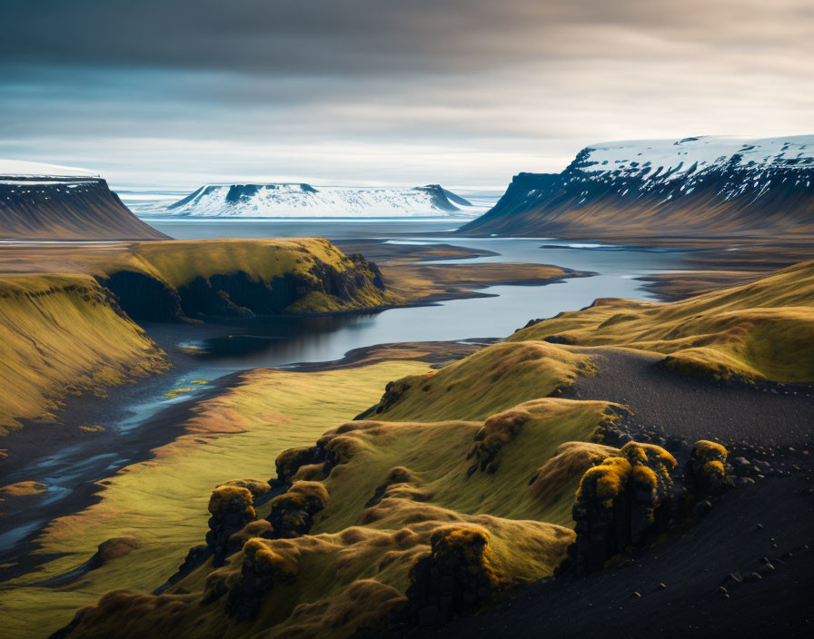 Icelandic landscape: moss-covered hills, river, snow-capped mountains