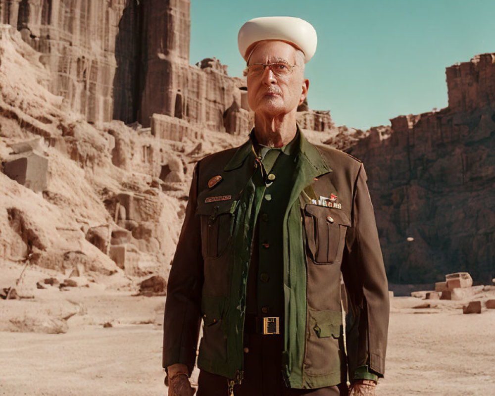 Elderly man in green military uniform with medals in desert canyon