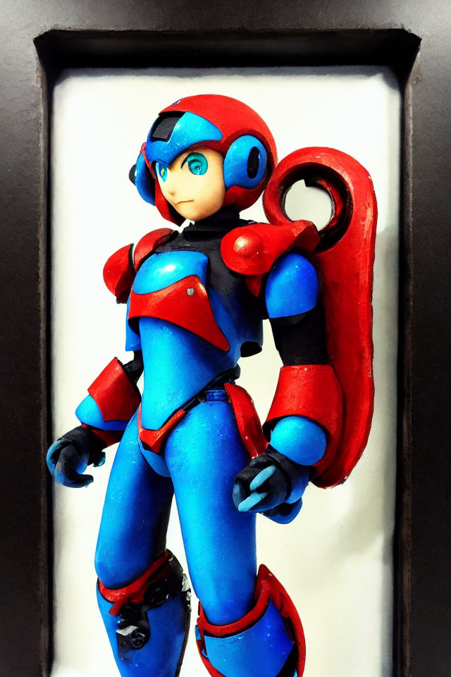 Blue-armored Mega Man figurine in red highlights, showcased in black frame