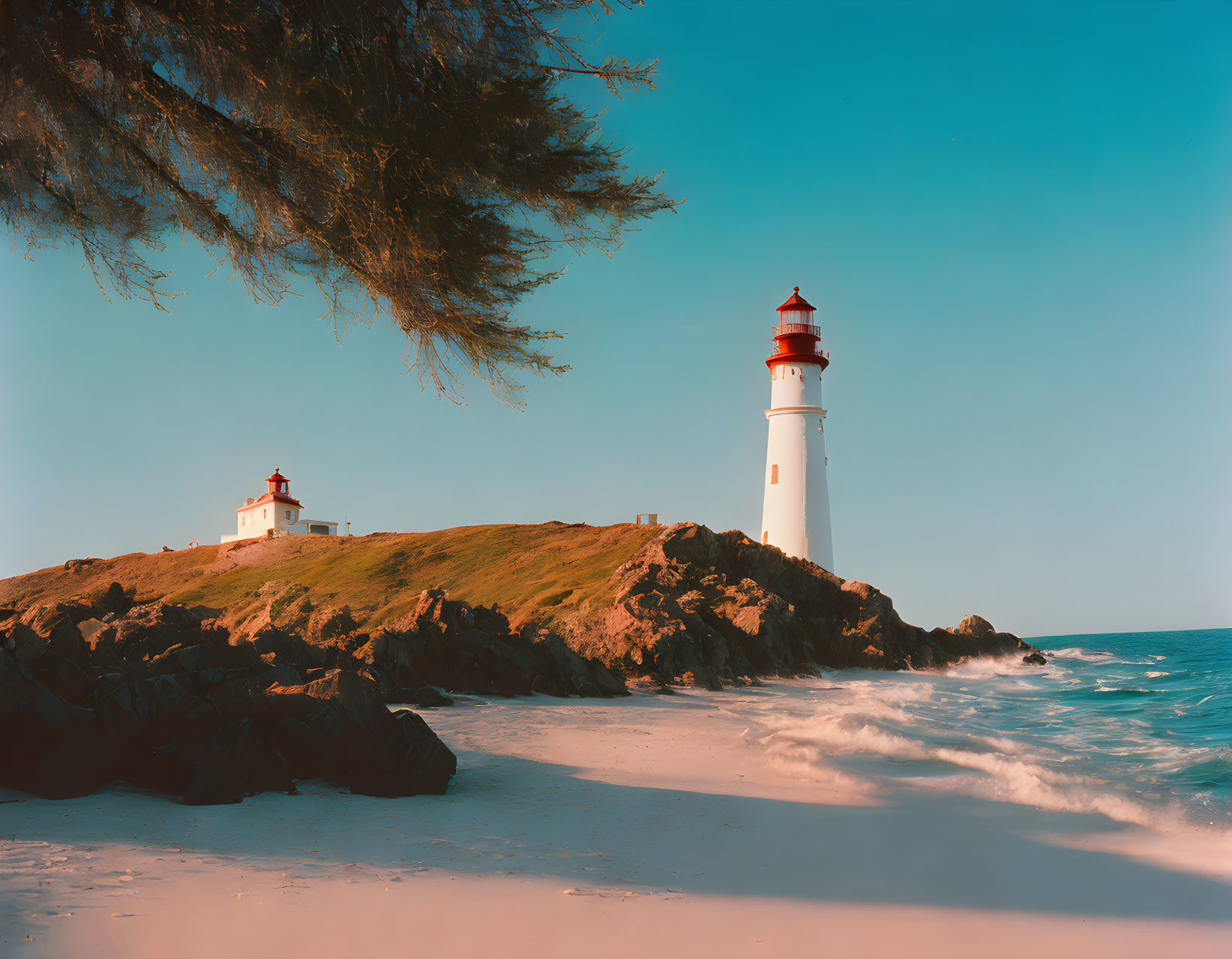 Scenic coastal view: white lighthouse on rocky outcrop by tranquil beach