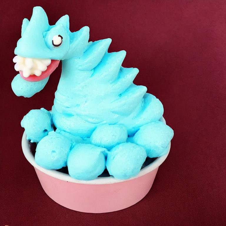 Blue Dragon-Shaped Ice Cream Scoop in Pink Bowl on Burgundy Background