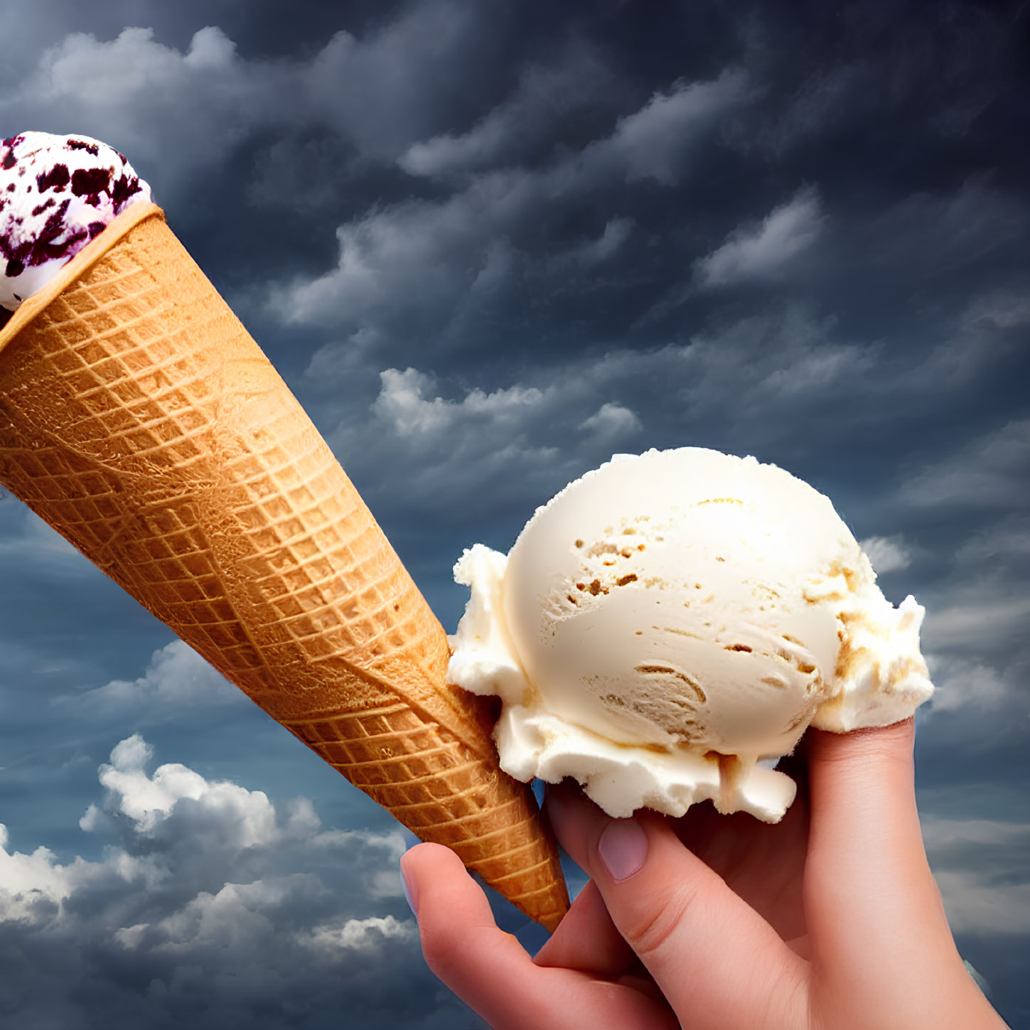 Vanilla ice cream scoop in waffle cone against cloudy sky