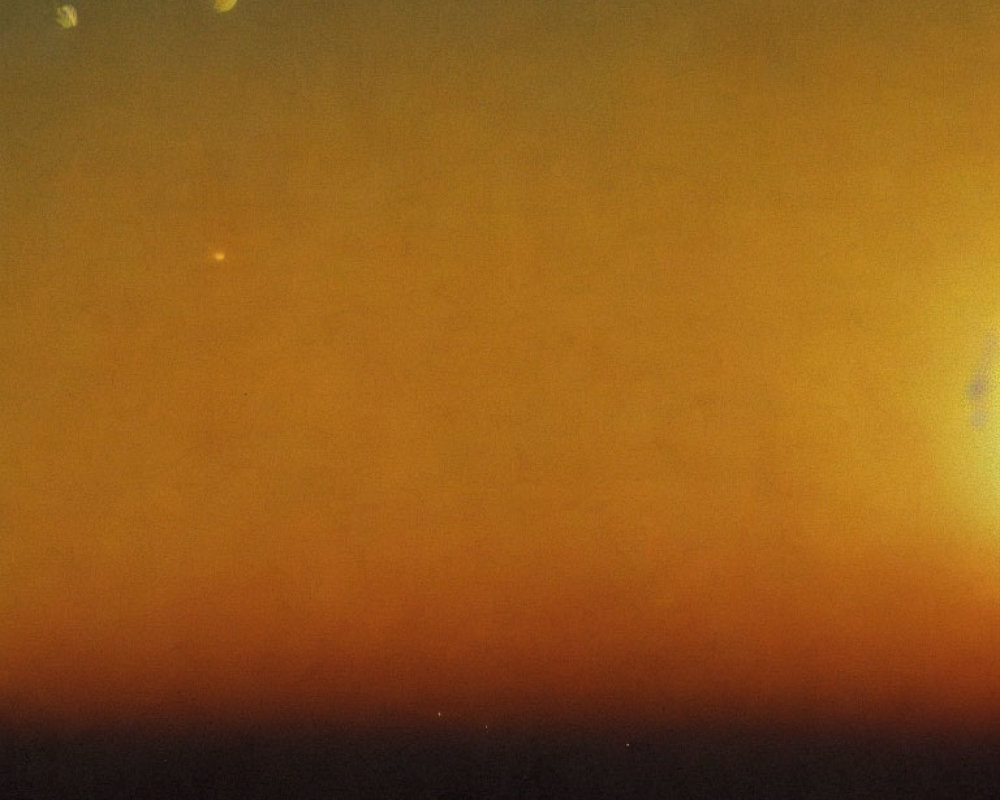 Grainy space image of star-like object and moons on orange-brown backdrop