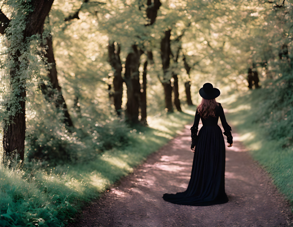 Person in Black Dress and Hat on Forest Path with Sunlight and Green Trees