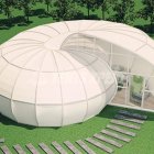 Futuristic egg-shaped house in vibrant garden