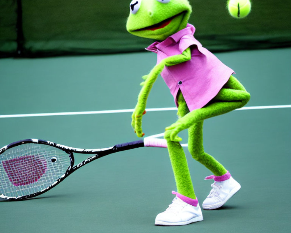 Green Kermit plush toy in pink shirt and white shorts playing tennis.