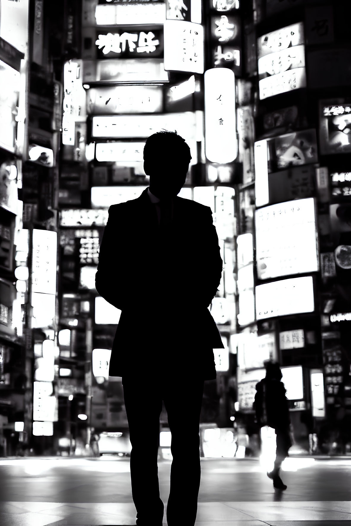 Silhouetted figure against neon-lit cityscape at night