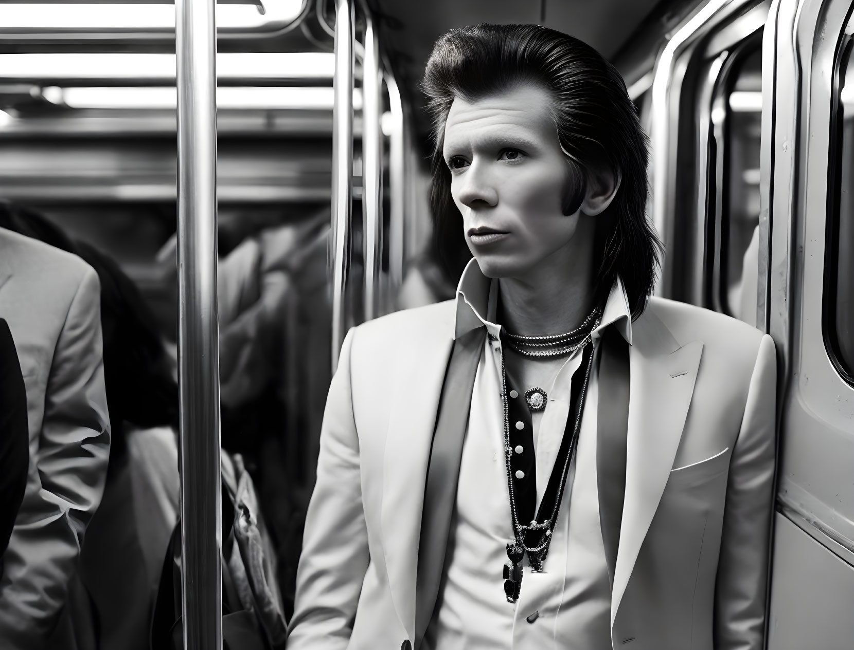 Fashionable individual in white suit with unique hairstyle on subway train gazes out window.