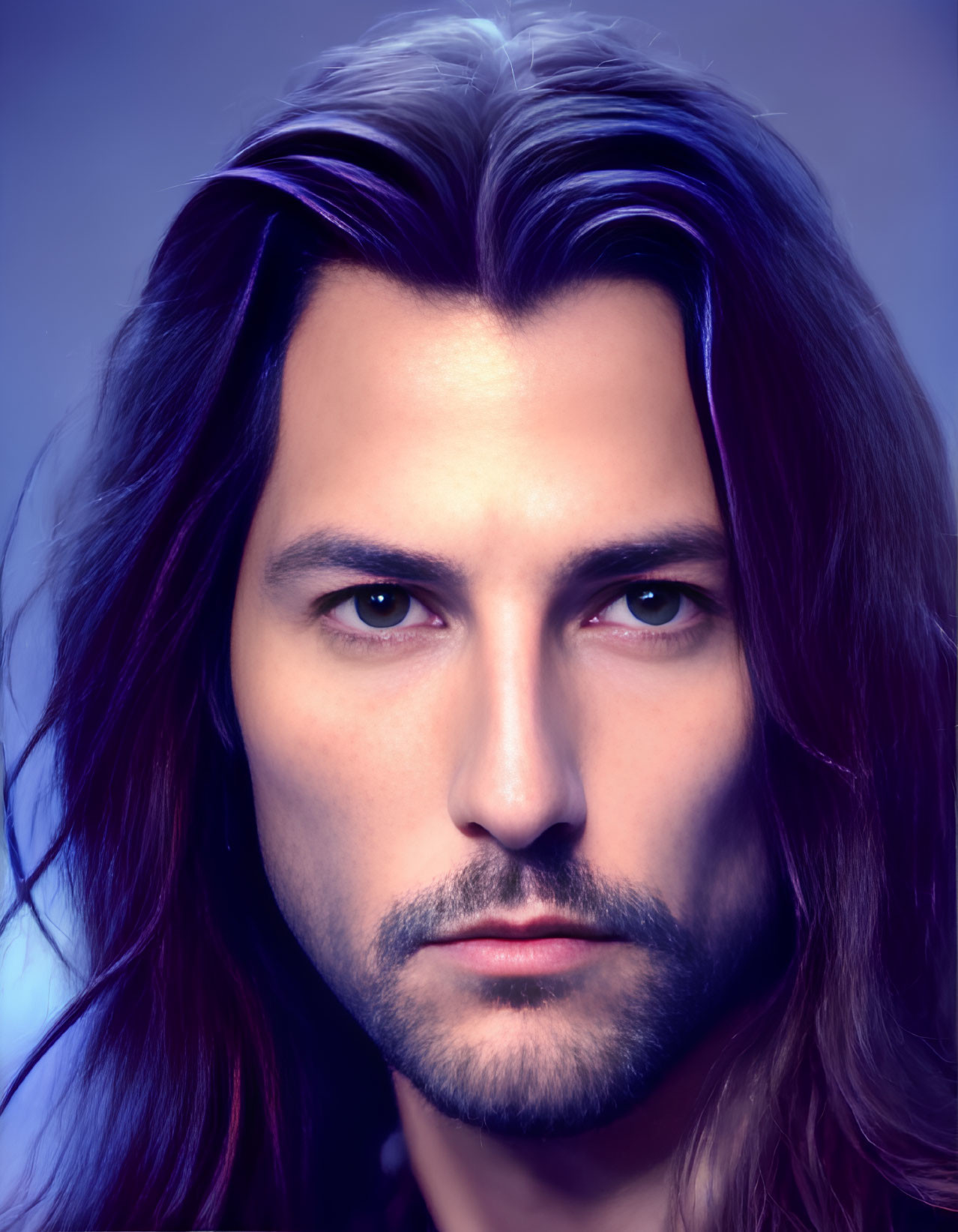 Portrait of man with medium-length dark hair, slight beard, intense eyes on violet gradient.