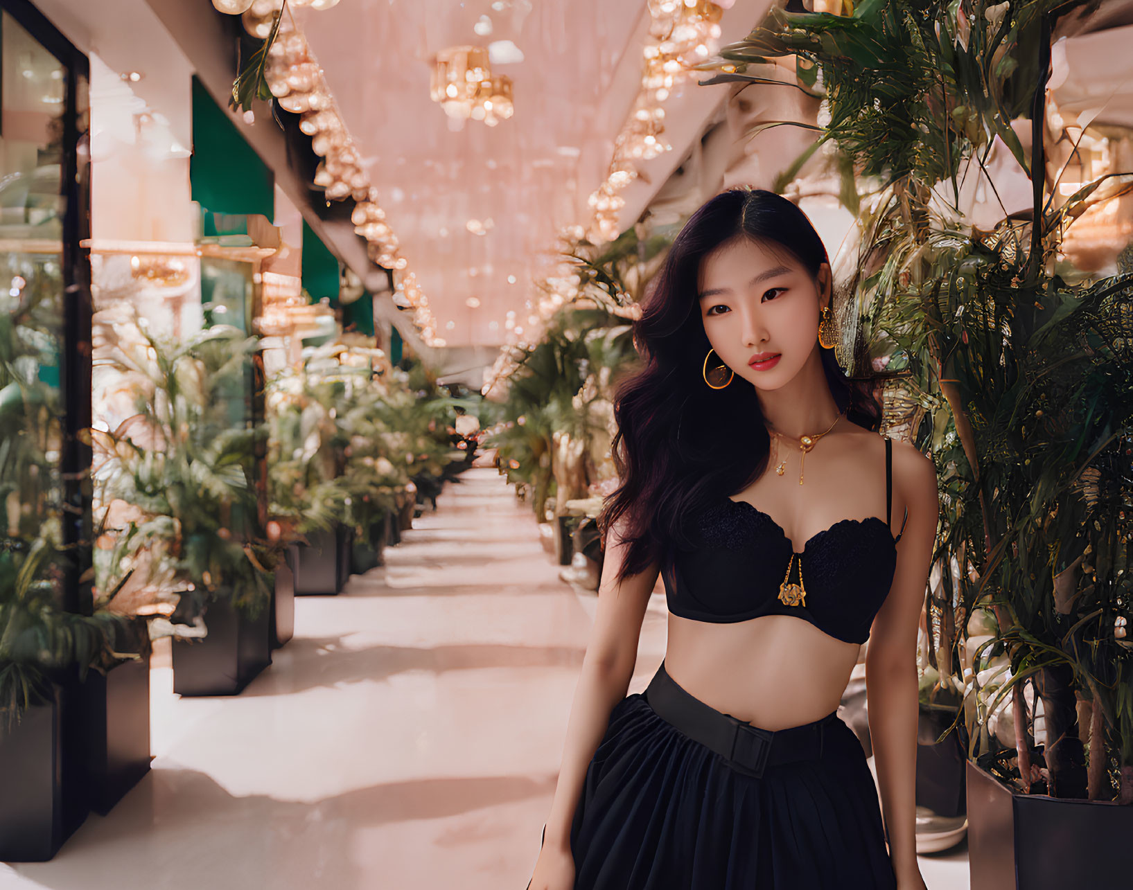 Woman in Black Crop Top and Skirt in Luxurious Interior with Plants and Chandeliers