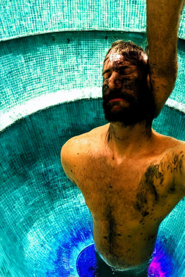 Bearded man in water with vibrant lighting reflections