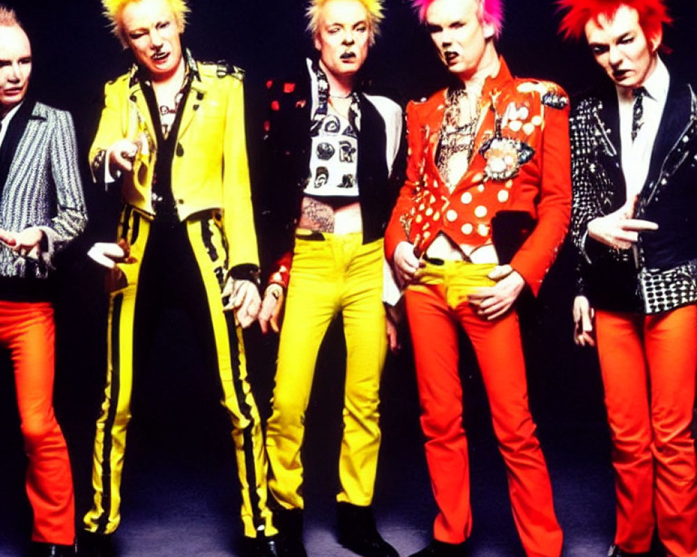 Five people in punk fashion with colorful mohawks and studded leather jackets on yellow backdrop