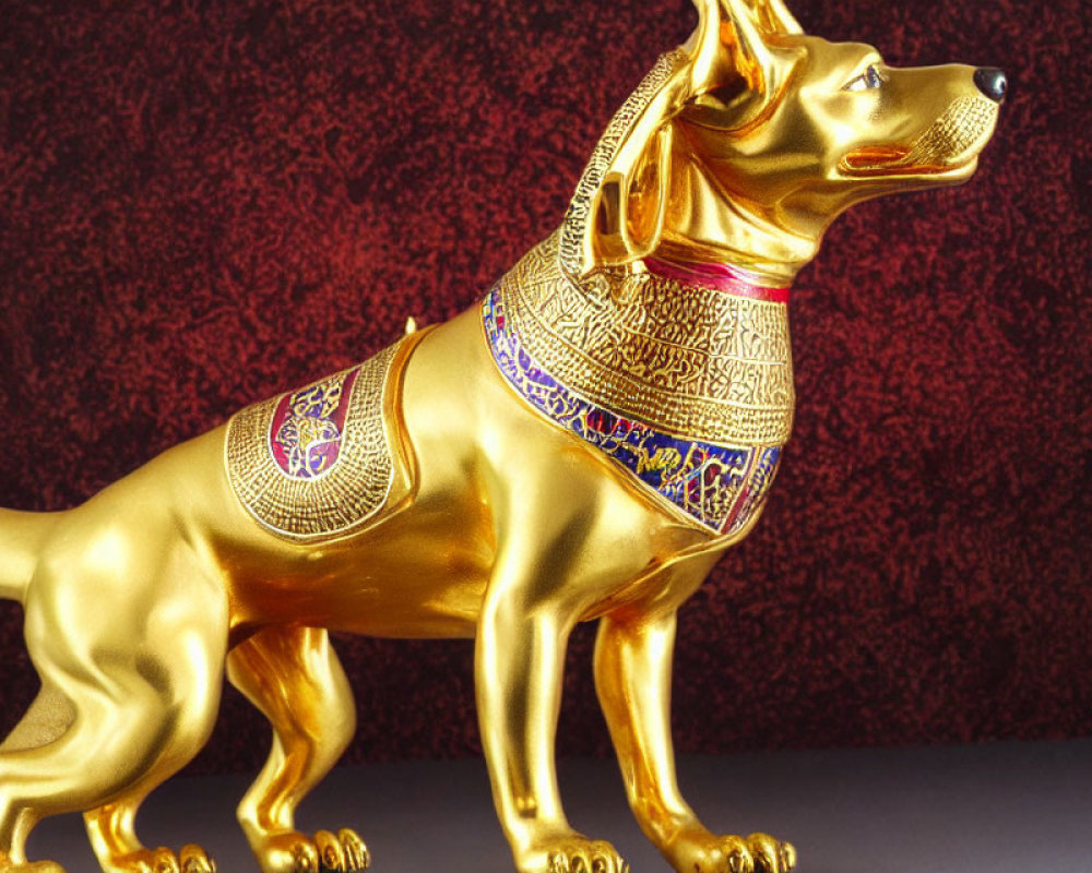 Golden dog statue with colorful patterns on red background