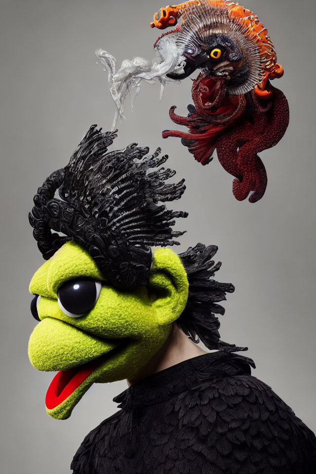 Surreal portrait featuring person with green puppet-like head and red floating creature