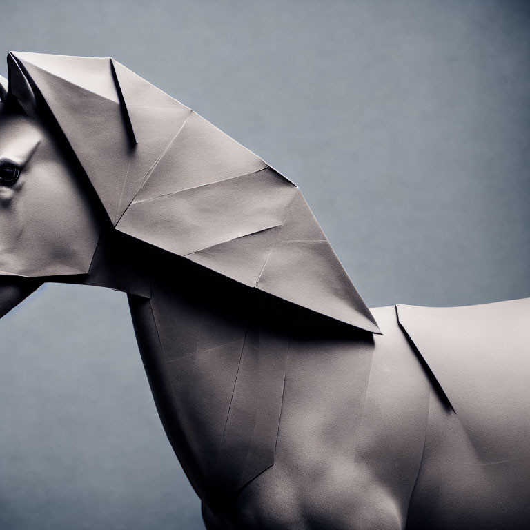 Detailed dark gray origami horse with intricate folds on muted background