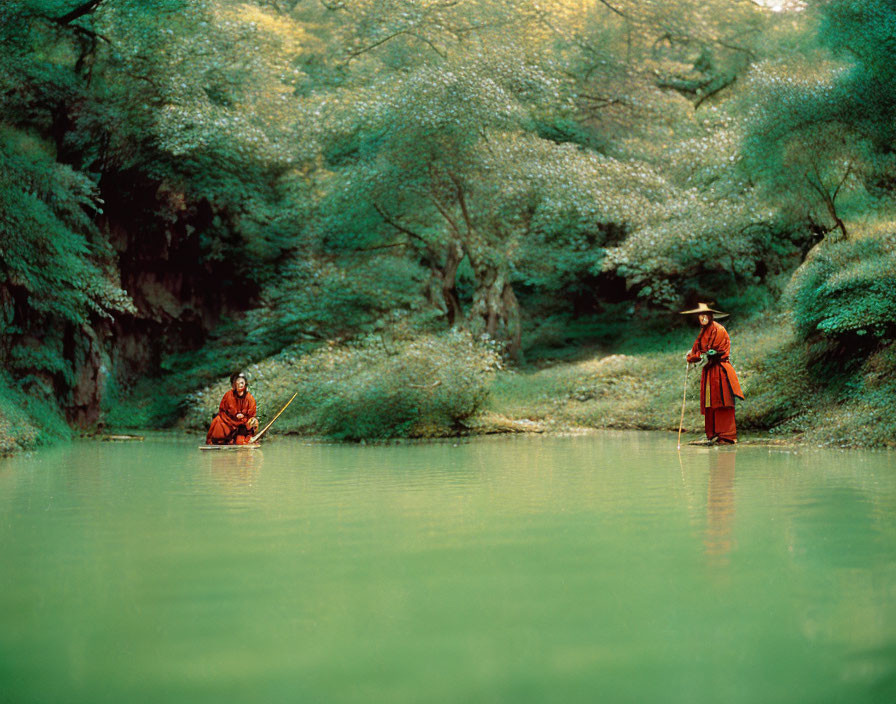 Two individuals in traditional robes and hats on boat and bank by serene green river.
