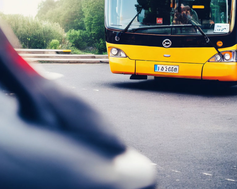 Yellow City Bus Partially Obscured by Blurred Car