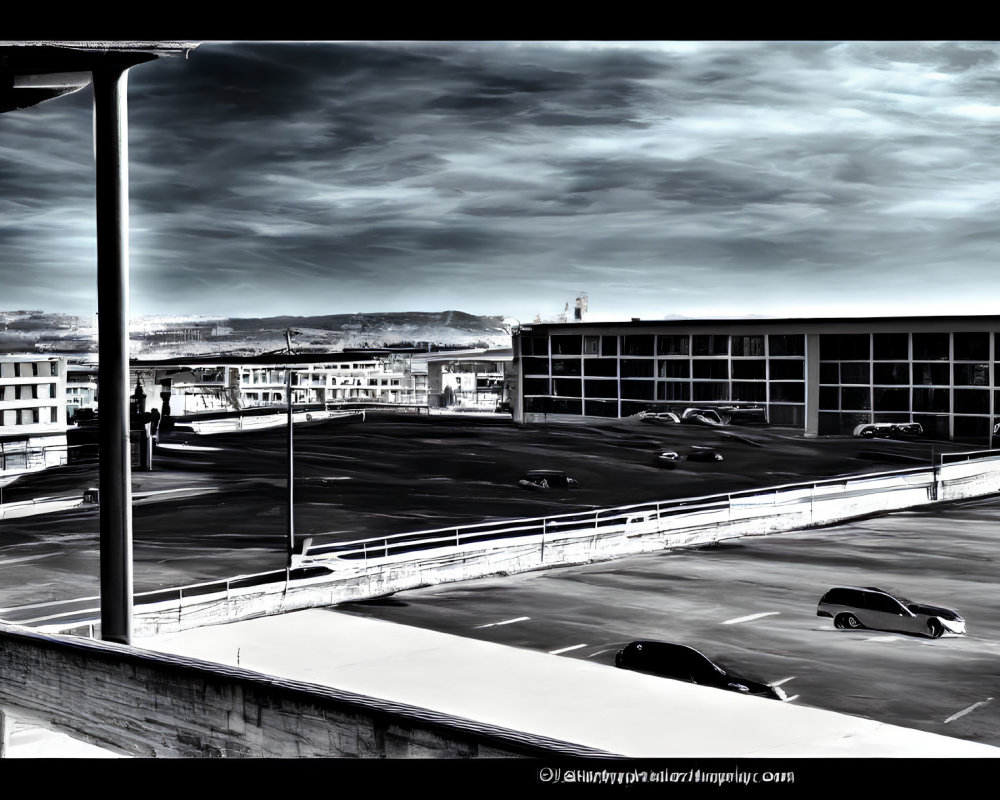 High-contrast parking lot scene with cars and buildings under dramatic sky