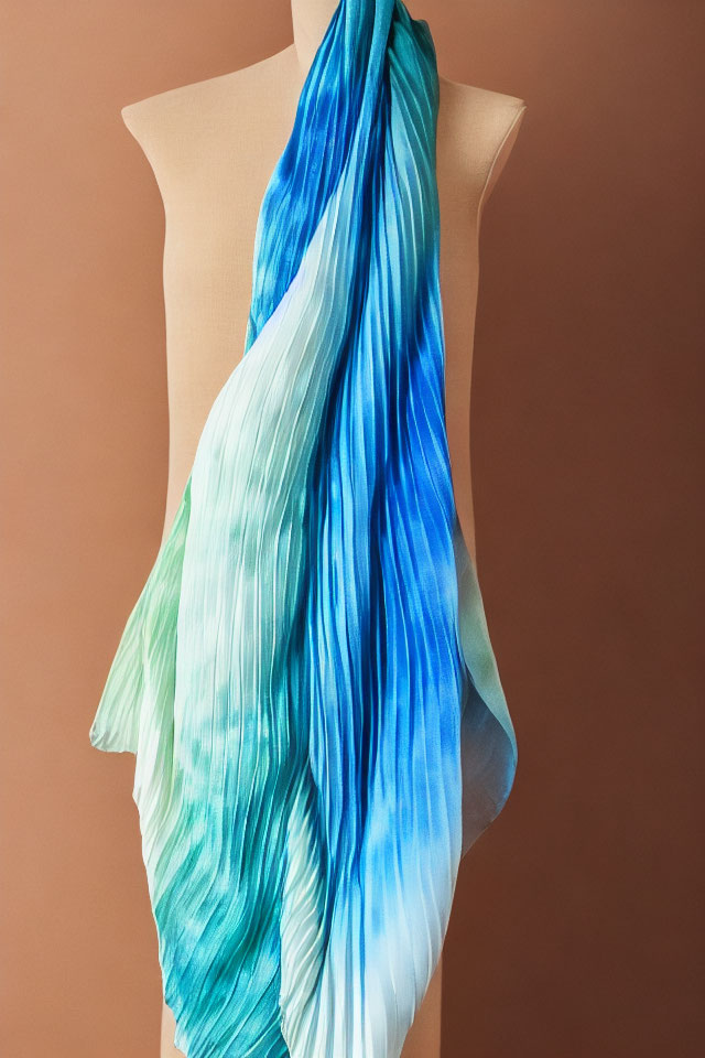 Blue and Green Gradient Silk Scarf on Mannequin Against Tan Background