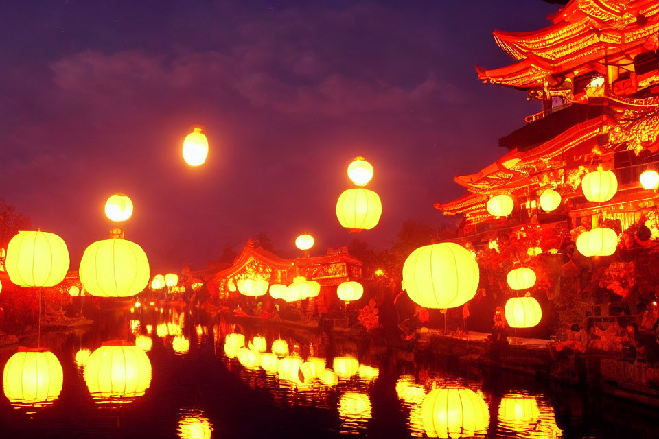 Traditional Chinese lanterns light up waterway and pagoda at twilight