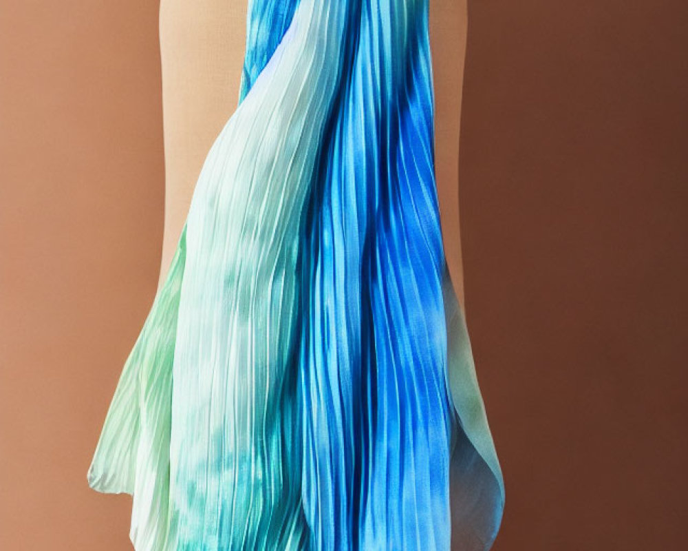 Blue and Green Gradient Silk Scarf on Mannequin Against Tan Background