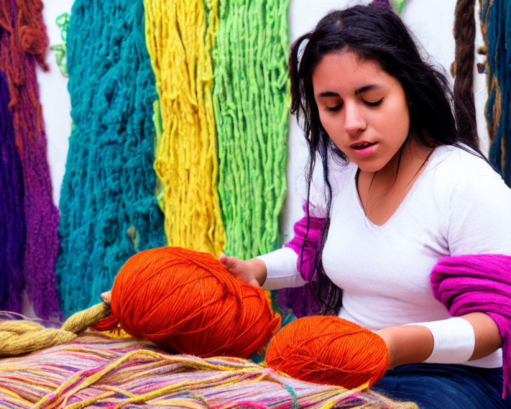 Young woman surrounded by colorful yarn skeins, handling bright orange ball.