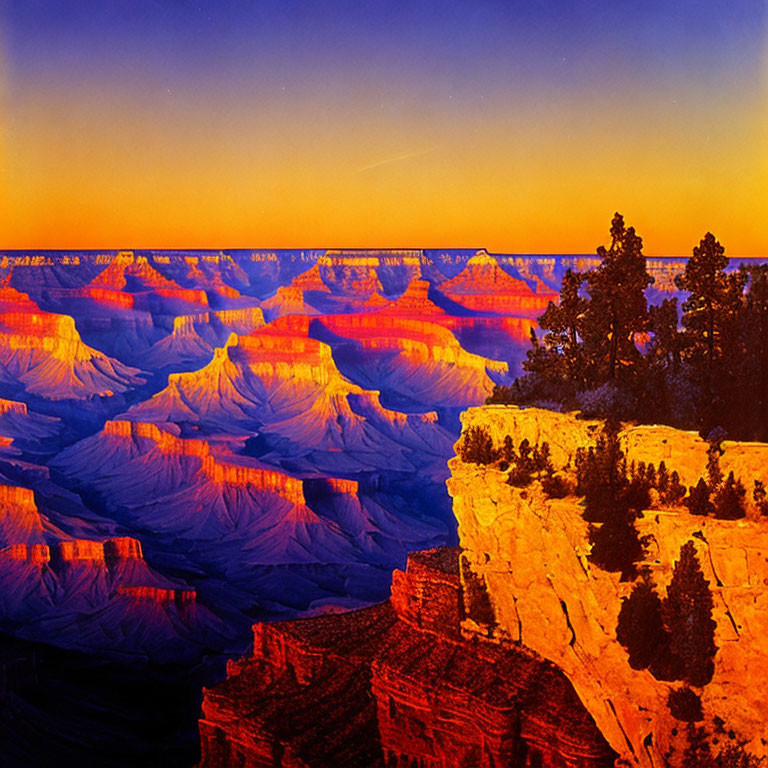 Colorful Grand Canyon sunset with textured rock layers and sparse greenery.