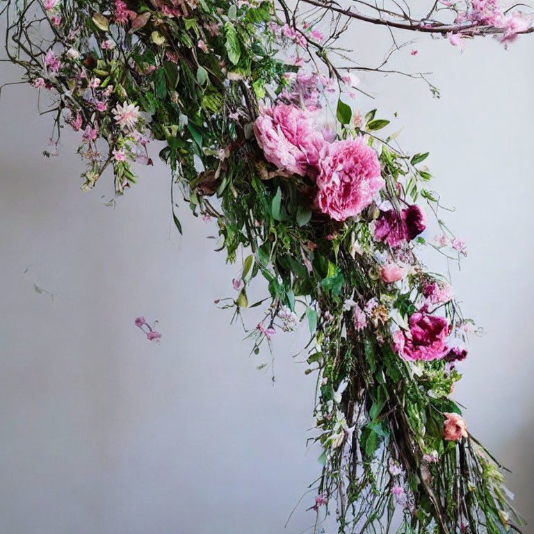 Pink peonies and delicate blooms in lush floral arrangement
