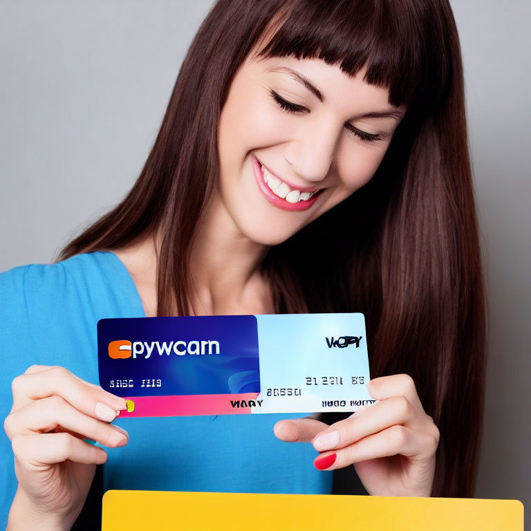 Smiling woman holding blue and white credit cards
