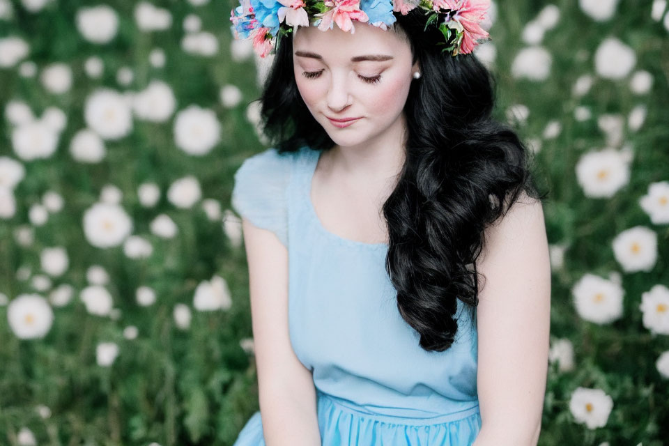 Woman in Blue Dress with Floral Crown Sitting in Daisy Field