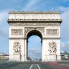 Long exposure photo of Arc de Triomphe with blurred traffic lights and crowds