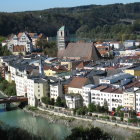 European town with historical buildings, river, castle, and greenery