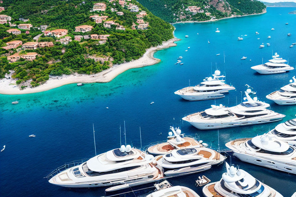 Luxury yachts moored near coastal resort with lush greenery and turquoise bay