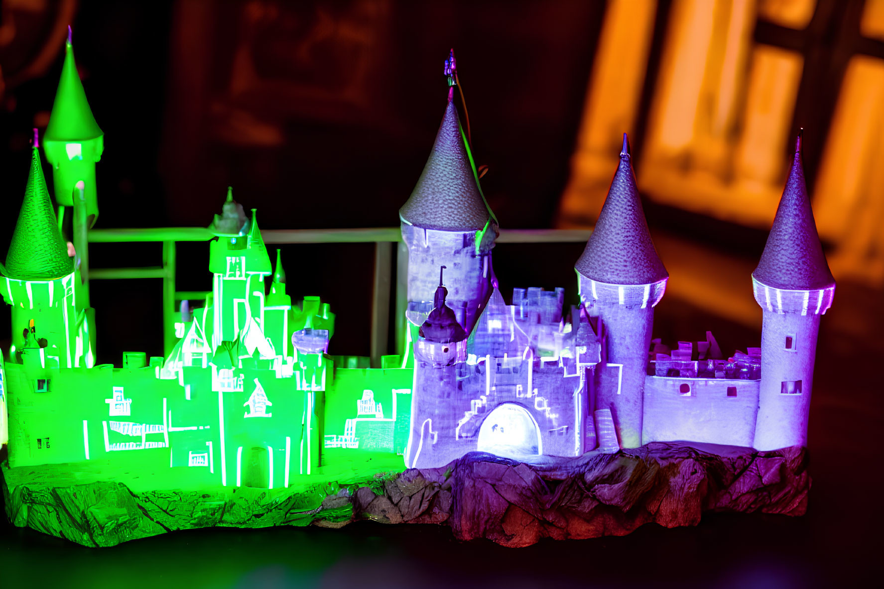 Miniature castle with vibrant green and purple lighting on dark background