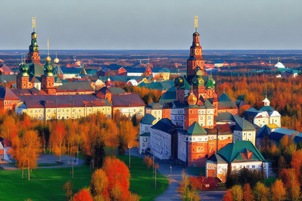 Historic monastery with green and golden domes in autumn setting
