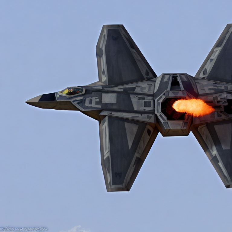 Military Jet with Angular Camouflage in Flight with Afterburner Flame