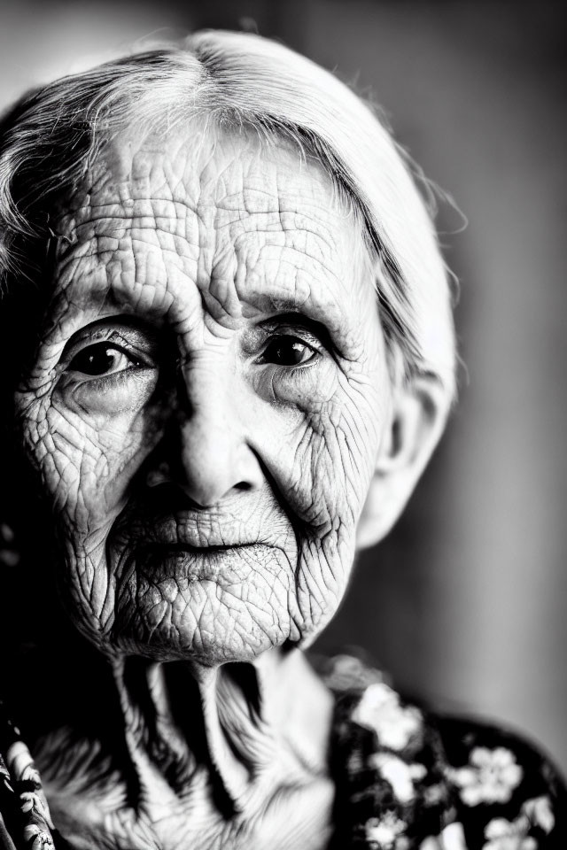 Elderly woman portrait in black and white with deep wrinkles and expressive eyes