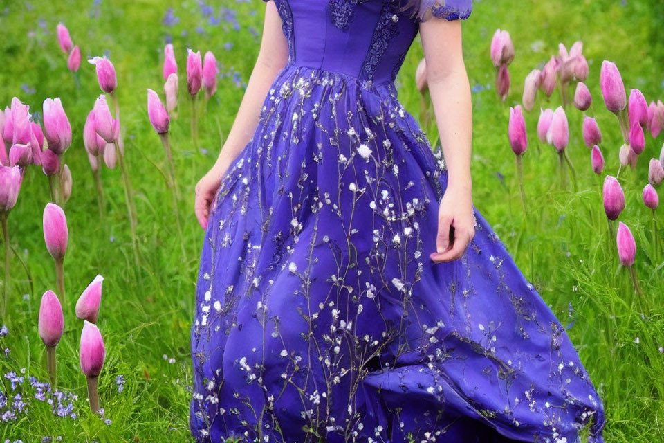 Person in Blue Dress Surrounded by Purple Tulips
